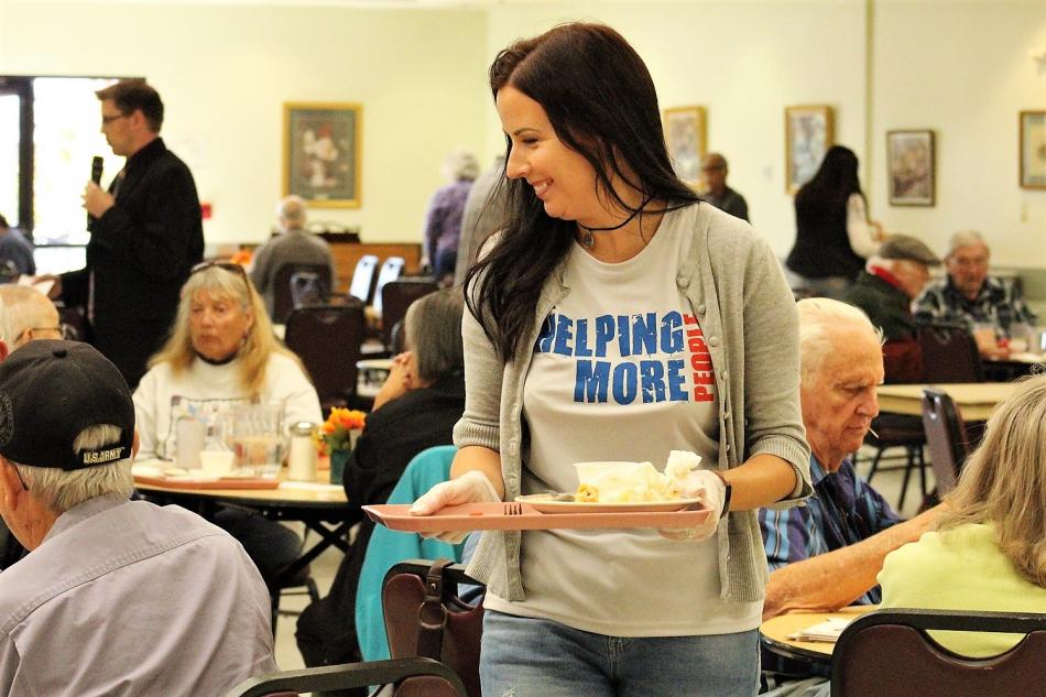 Greater Nevada Credit Union employees volunteer in the Carson City Senior Center dining room.