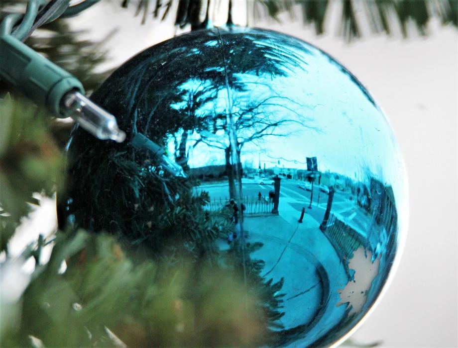 Reflection of Carson Street in a blue Christmas tree ornament on the Capitol grounds.