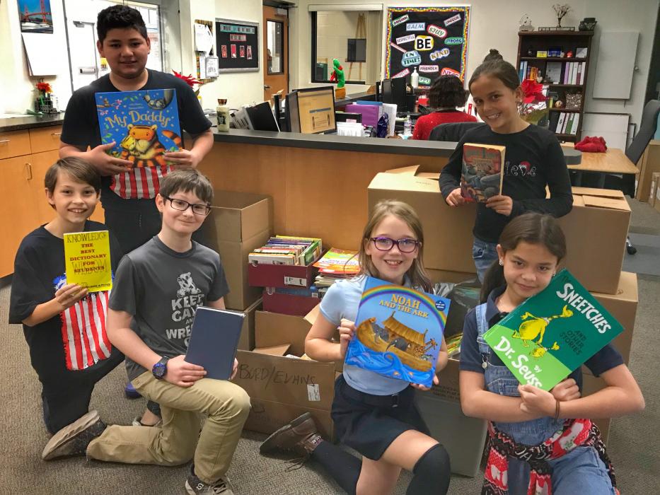 Bordewich Bray Students display some of the more than 10,000 books to be donated to schools in Paradise, Calif.