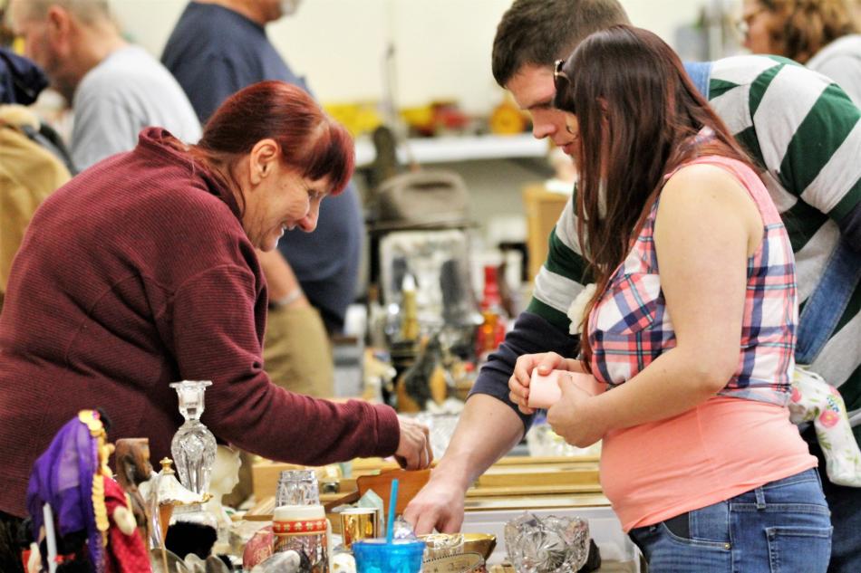Photos by Brett Fisher. A vendor interacts with shoppers Saturday inside the Fuji Park Exhibit Hall.