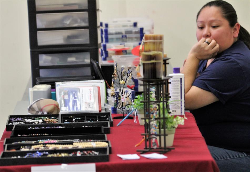 Vendor Jenelle Bryan displays her handmade jewelry for shoppers Saturday at the Flying Pig Flea Market.
