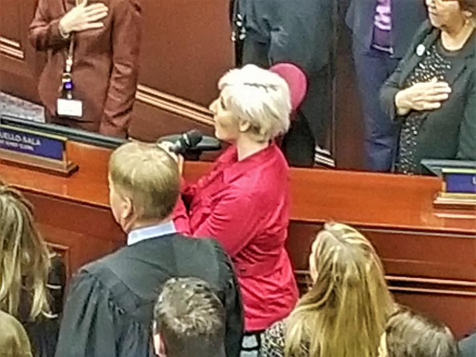 Music teacher and performing artist Christina Bourne sings the National Anthem at the Nevada Legislature.