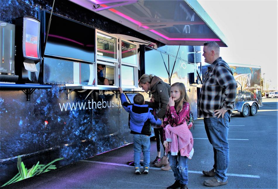 The Emery Family checks out the menu at the street-side order window.