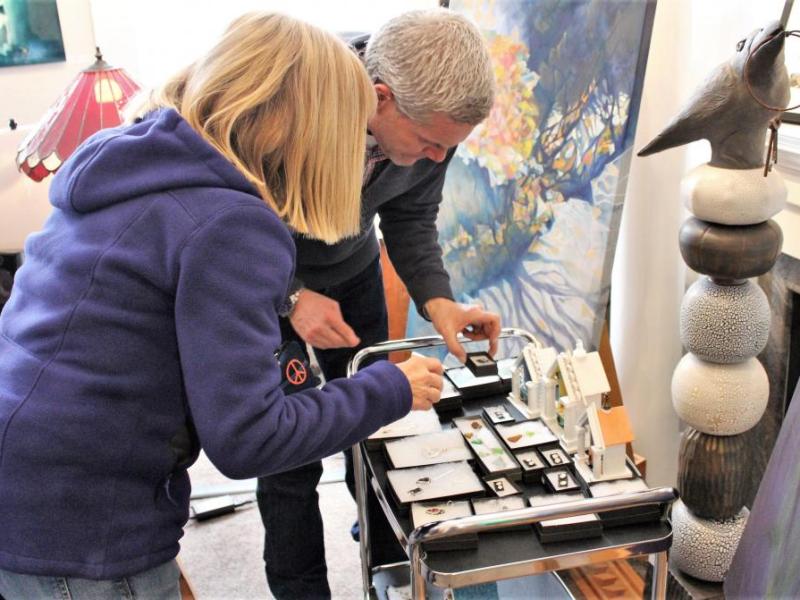 Photo by Brett Fisher. Jeffery Pace of Artsy Fartsy Art Gallery in Carson City helps a customer select jewelry.
