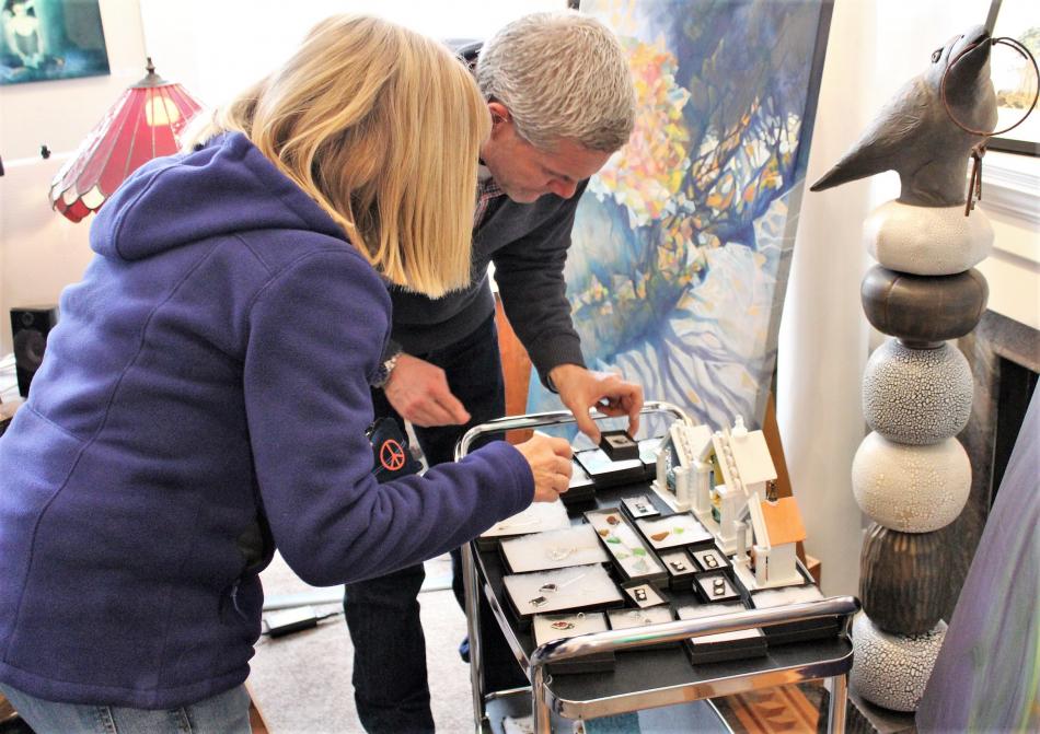 Photo by Brett Fisher. Jeffery Pace of Artsy Fartsy Art Gallery in Carson City helps a customer select jewelry.