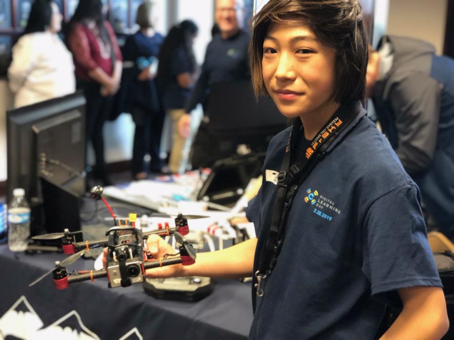 Jake Xie displays the drone he built from a DIY tech kit.