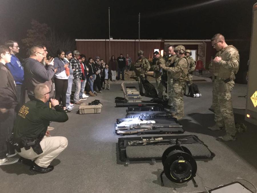 Students learning about the SWAT team.