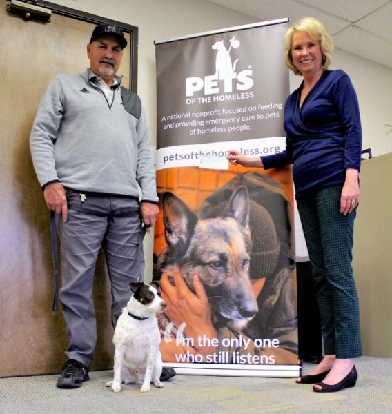 Photo by Brett Fisher. Dan Wilson and Bo-Ty present a check to Genevieve Frederick Thursday.