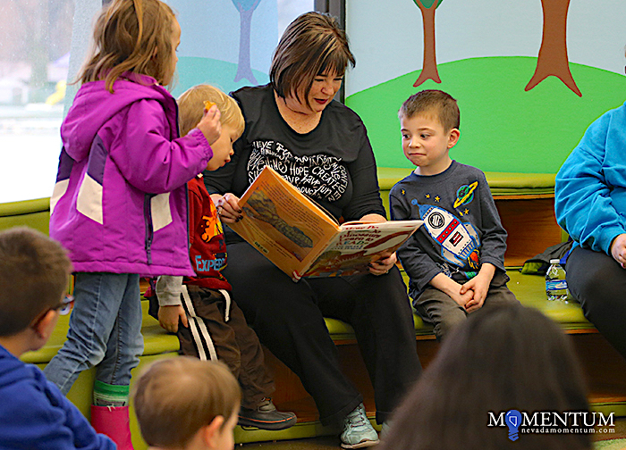 Photo by Cathleen Allison/Nevada Momentum. Carson City Supervisor Lori Bagwell reads to children at the Carson City Library.