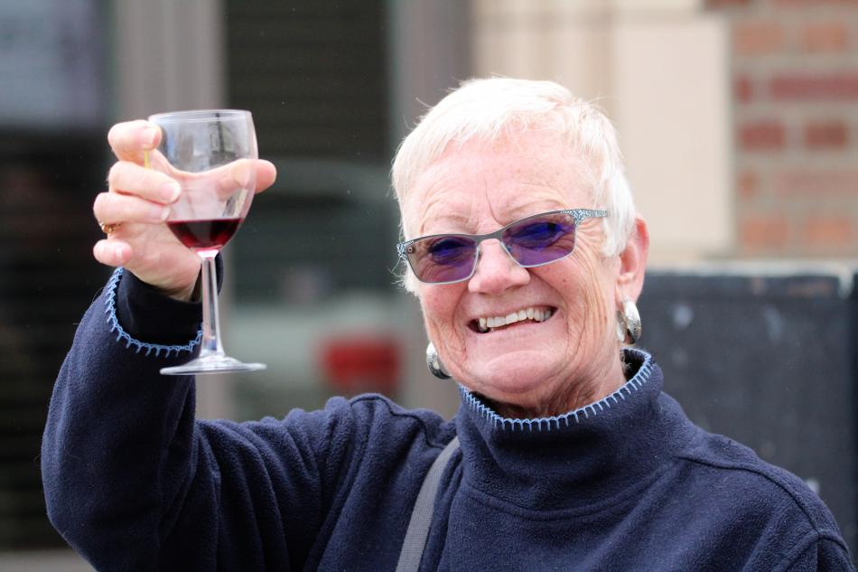 Photos by Brett Fisher. A Wine Walk guest toasts the camera Saturday on W. Telegraph Street.