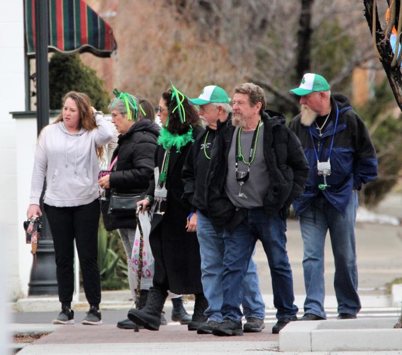 Wine Walk guests dresses in St. Patrick's Day green.