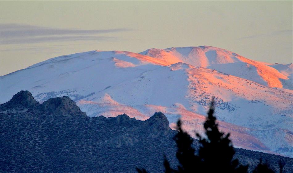 Photo by Brett Fisher. Sunset glows on the snow-covered Pine Nut Range southeast of Carson City.