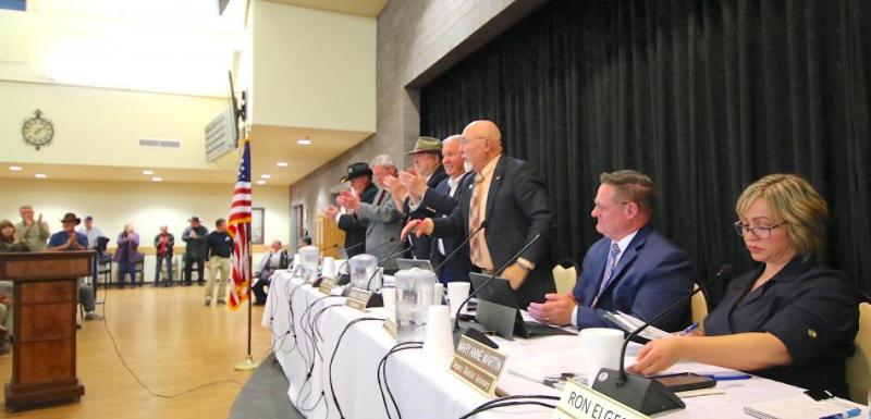 Board of County Commissioners give a standing ovation following passing of resolution.