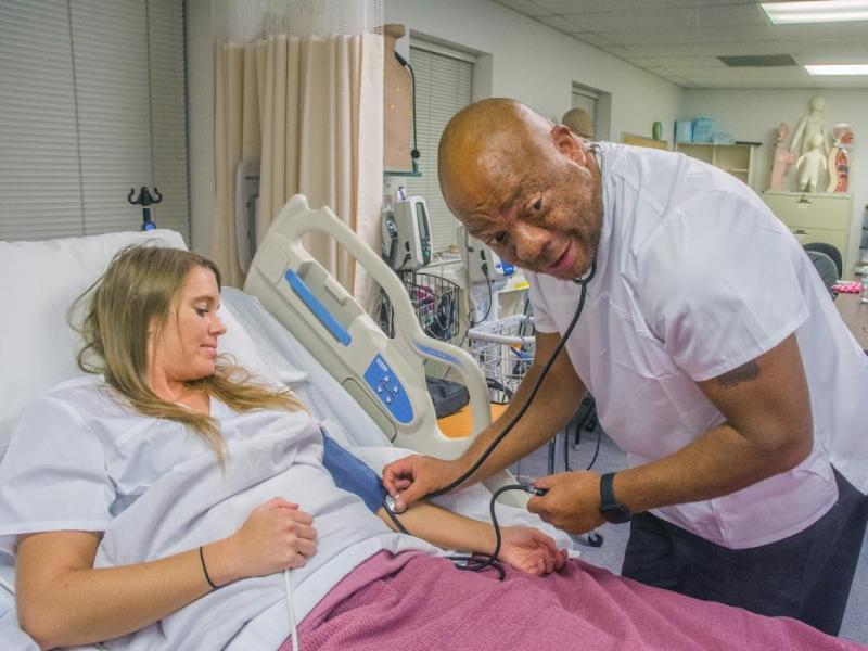 Clifton Bullock, right, and Kendell Oliver work in a CNA class at Western Nevada College’s Fallon campus.
