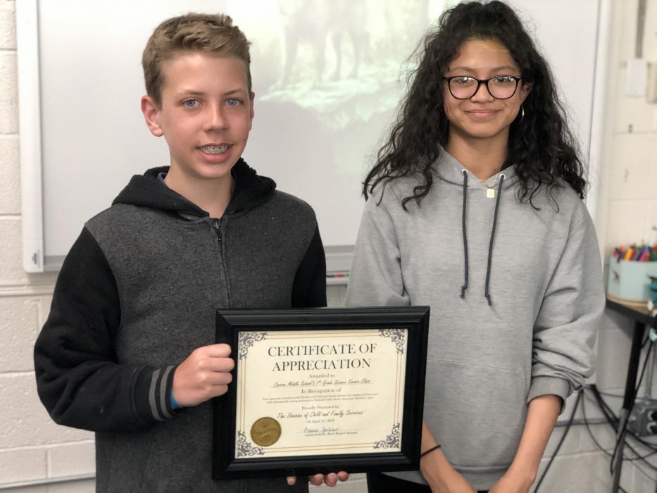 Ethan Long and Annalisa Torres-Morales accept a certificate of appreciation from the Nevada Division of Child & Family Services.