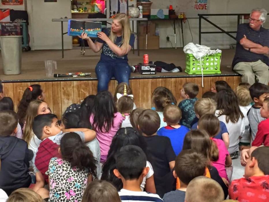 Artist in Residence Adriane Wacker Reads a book to gradeschoolers at Fritsch Elementary School.