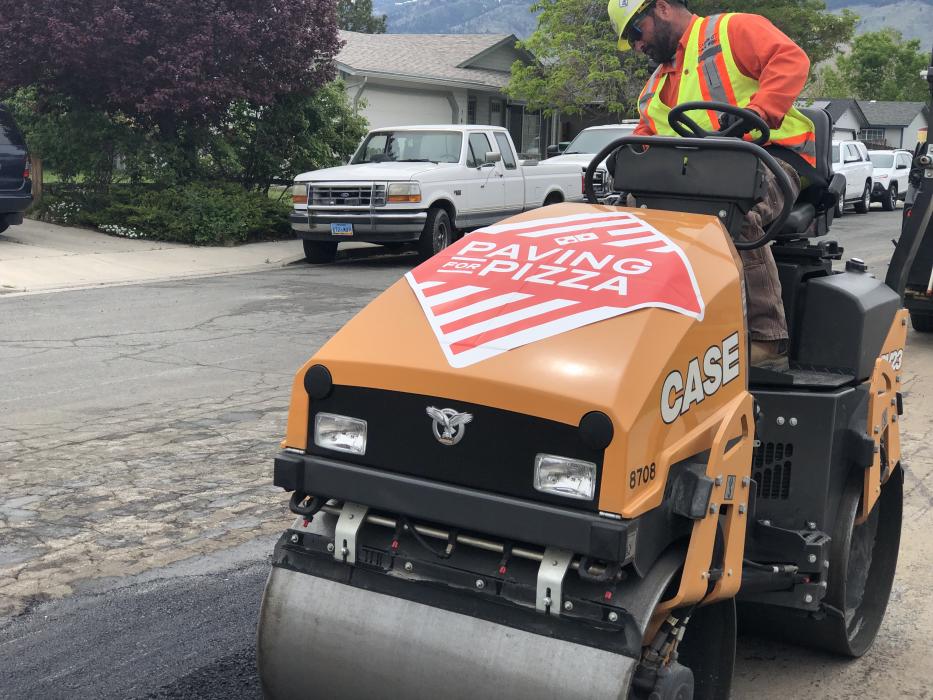 Eric Engles (Roller Operator) presses the filled pothole.