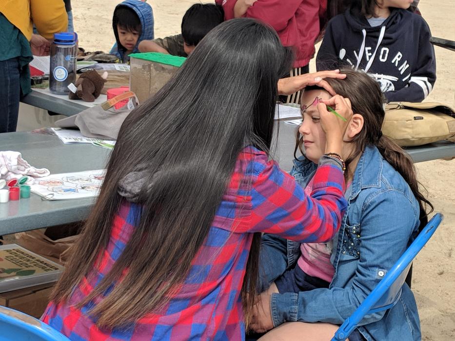 Kids of all ages lined up for animal face paintings.