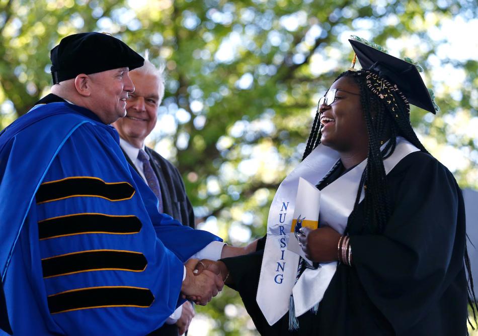 President Dr. Vincent Solis and Nevada Gov. Steve Sisolak congratulate graduates during the 2019 commencement ceremony Monday.