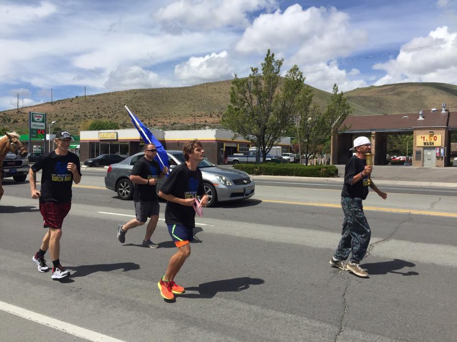 Tyrone Schultz runs the torch through Carson City Friday