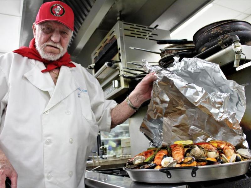 Photos by Brett Fisher. Chef Don Pepe Paz with a fully cooked 40-lb pan of Paella.