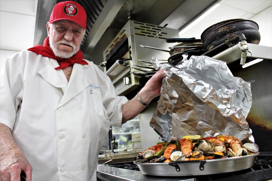 Photos by Brett Fisher. Chef Don Pepe Paz with a fully cooked 40-lb pan of Paella.