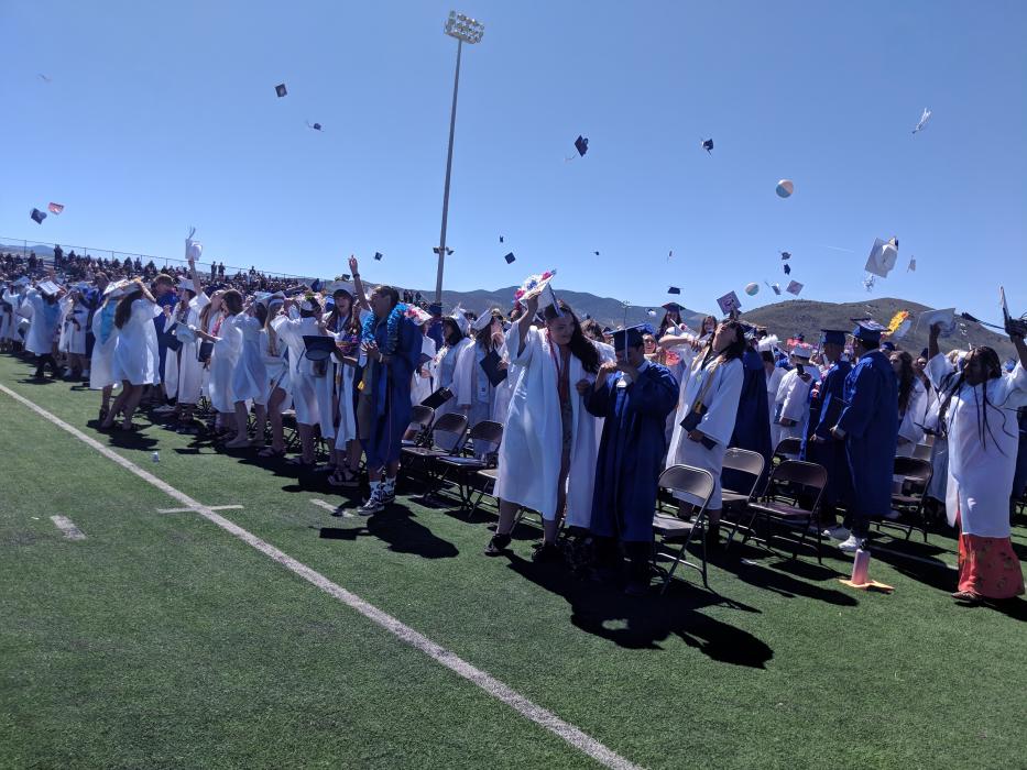 Caps filled the bright blue sky to commence the Carson High School graduation.