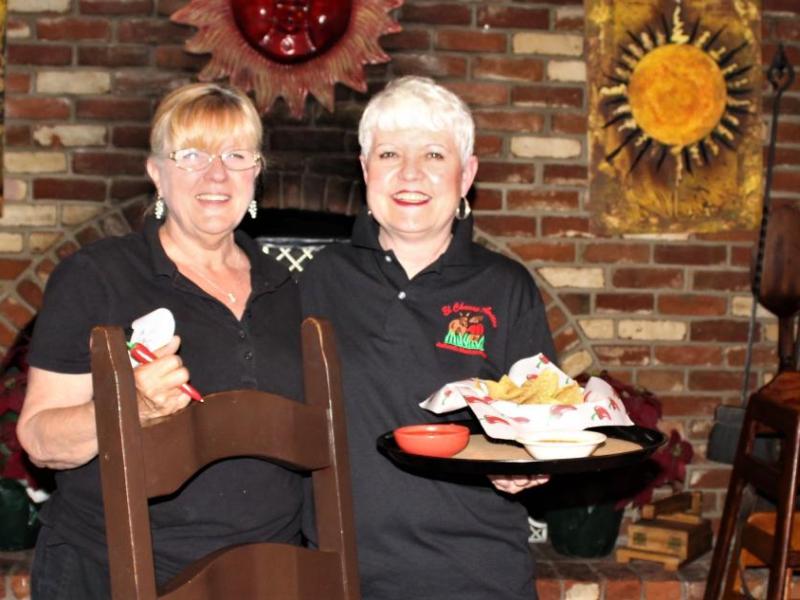 Long time El Charro Avitia servers Jo Ratledge (left) and Pam Ventling prepare to serve customers. Photo: Ronni Hannaman