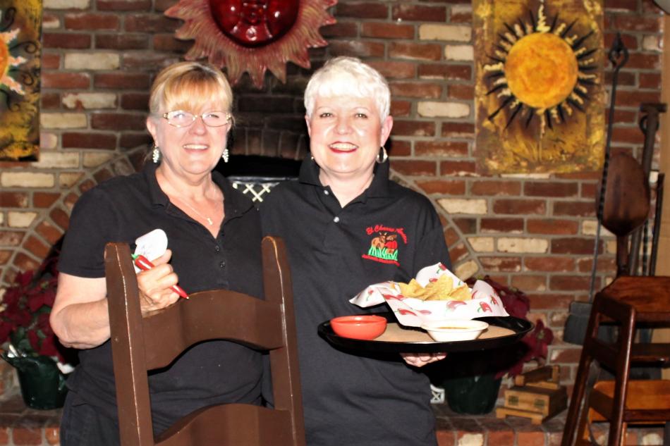 Long time El Charro Avitia servers Jo Ratledge (left) and Pam Ventling prepare to serve customers. Photo: Ronni Hannaman