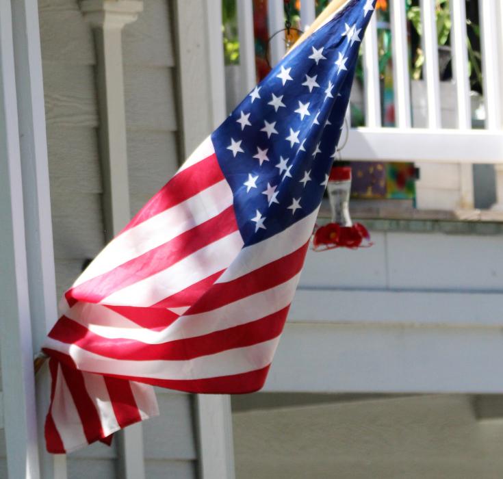 A partially furled American flag at a home on W. Robinson Street.