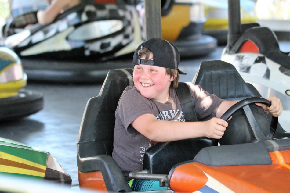 A youth operates a bumper car at the Fourth of July Carnival in Mills Park.