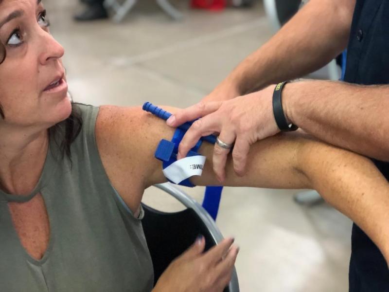 Photos by Dan Davis. Fremont Elementary Principal Jennifer Ward-DeJoseph has a tourniquet placed on her arm.