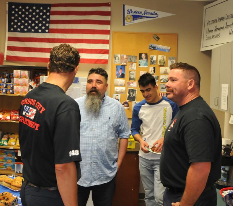 WNC Veterans Resource Center Coordinator Vincent Rivera talks with Carson City Fire Department Station 51 personnel.