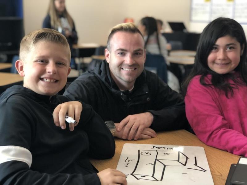 Mr. Steven Vradenburg and fifth grade students Logan McGee and Jennica Weston.