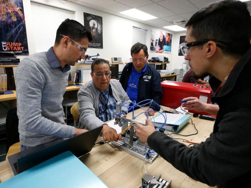 A group of instructors from technology colleges in Mexico train on mechatronics this week with Professor Emily Howarth at WNC.
