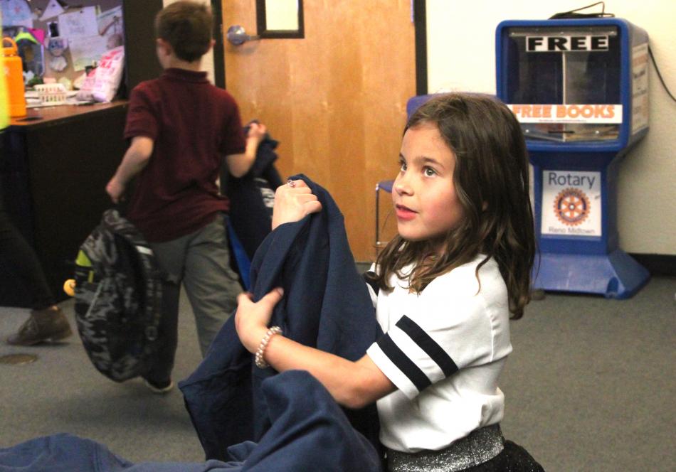  A member of the Boys & Girls Clubs of Western Nevada receives her new sweatshirt at the Club’s annual Christmas party.