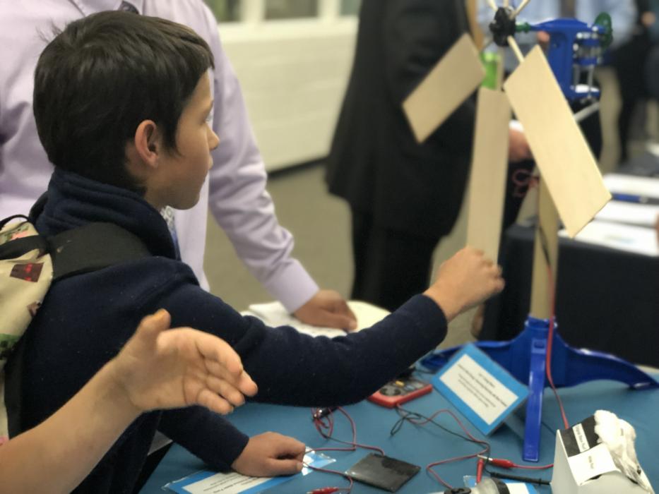 An Empire Elementary School student interacts with a wind turbine display.