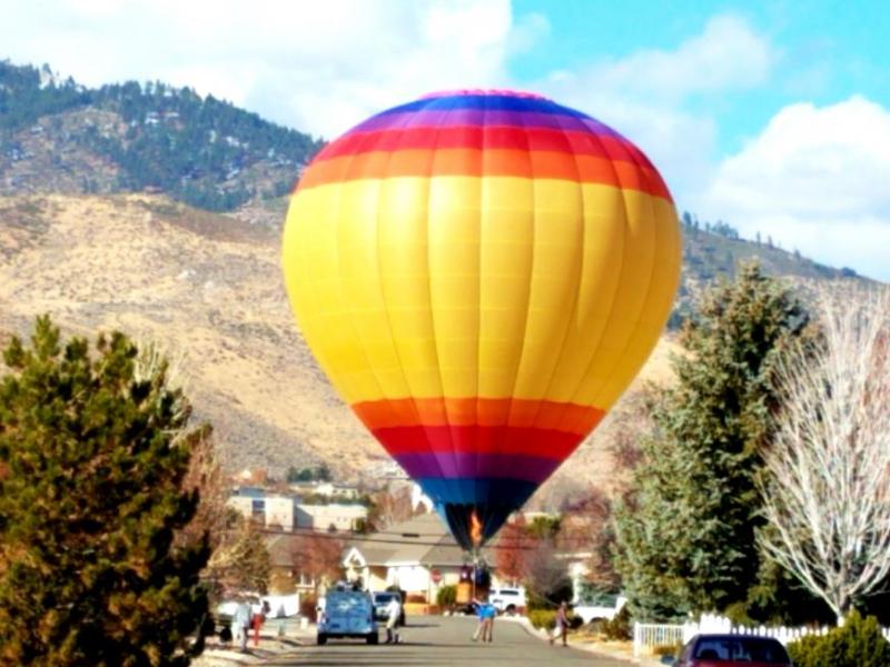 Photo by Brett Fisher. A hot air balloon attempts to lift off from Evergreen Drive.