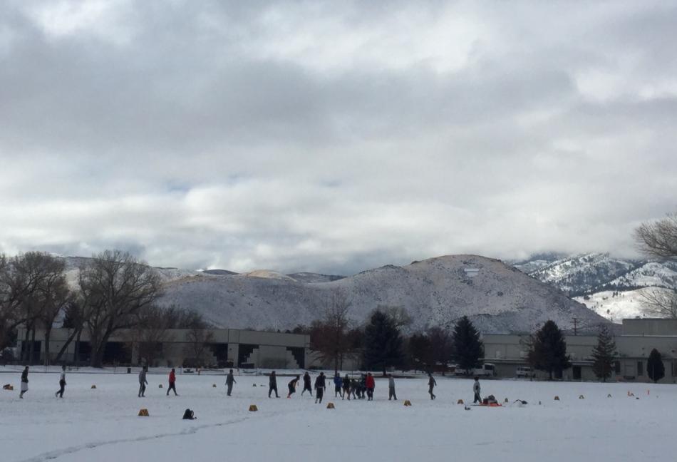 These soccer players take in a match in the snow Thursday at Mills Park.
