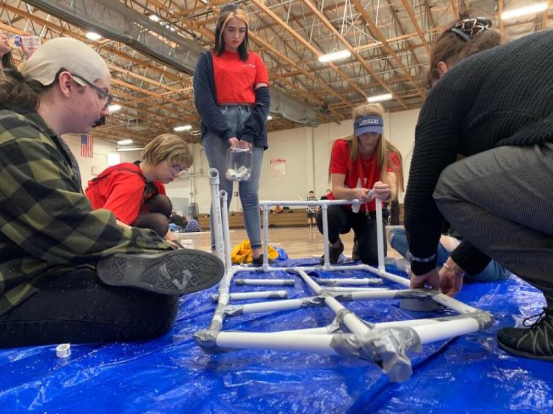 PHS students construct a boat from PVC, duct tape, and tarp.