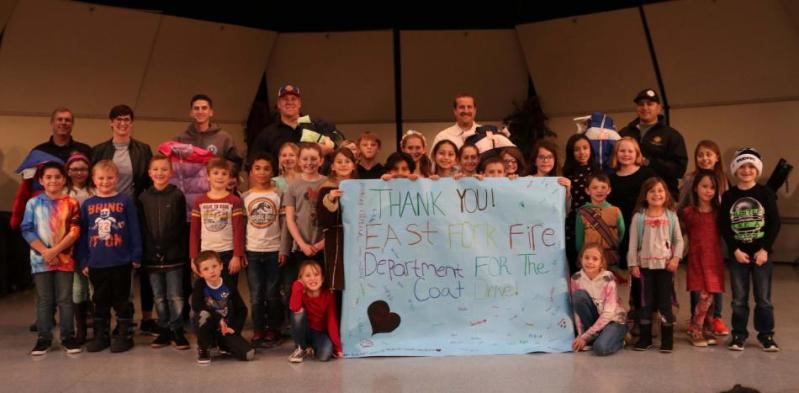 Members of the East Fork Professional Firefighters deliver brand new, warm winter coats to members of the Boys & Girls Clubs.