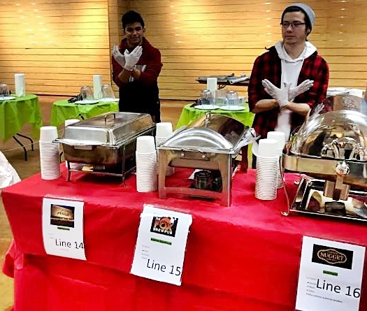 CHS seniors Ivan Villegas Martinez and Mark Dodd working on their Senior Projects with the Empty Bowls fundraiser FISH.