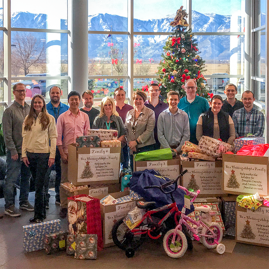 Bently Nevada employees celebrate their success in gathering Christmas gifts for 11 Carson City and Douglas County families