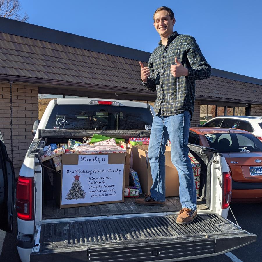 Electrical Engineer Greg Anderson delivers a portion of the 15 boxes of Christmas gifts