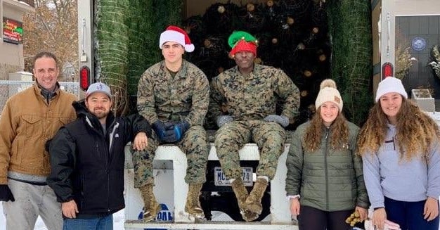 CHS Fellowship of Christian Athletes area director Timothy Plummer, bottom left, delivering 75 Christmas trees to Marines.