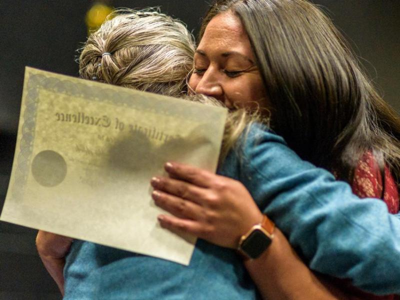 Graduate Marisol Sherlock hugs WNC Instructor Hallie Murphy during a 2019 ceremony.