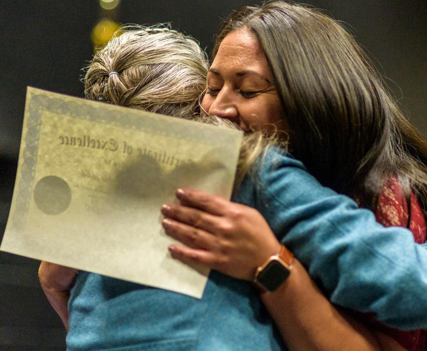 Graduate Marisol Sherlock hugs WNC Instructor Hallie Murphy during a 2019 ceremony.