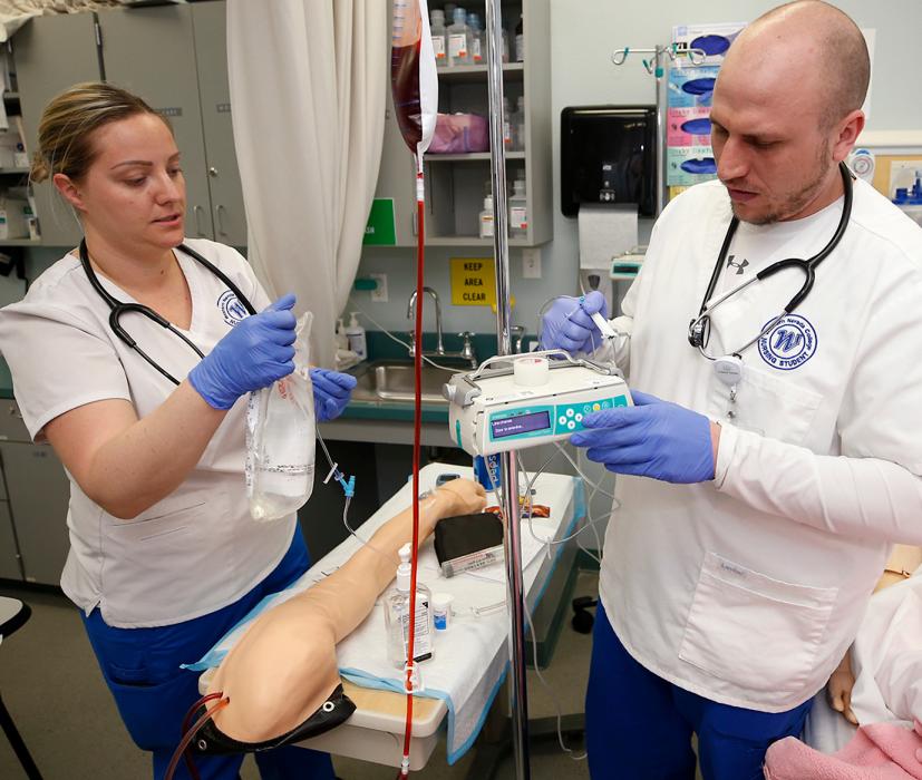 Kattie Pagmossin and Jacob Phillips work in a nursing lab with prosthetics at WNC last spring in Carson City.