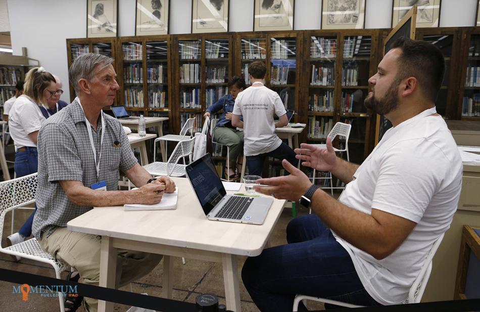 Google coach Tony DeRosa, right, talks with Mark Walker at the Grow with Google event at the Carson City Library.