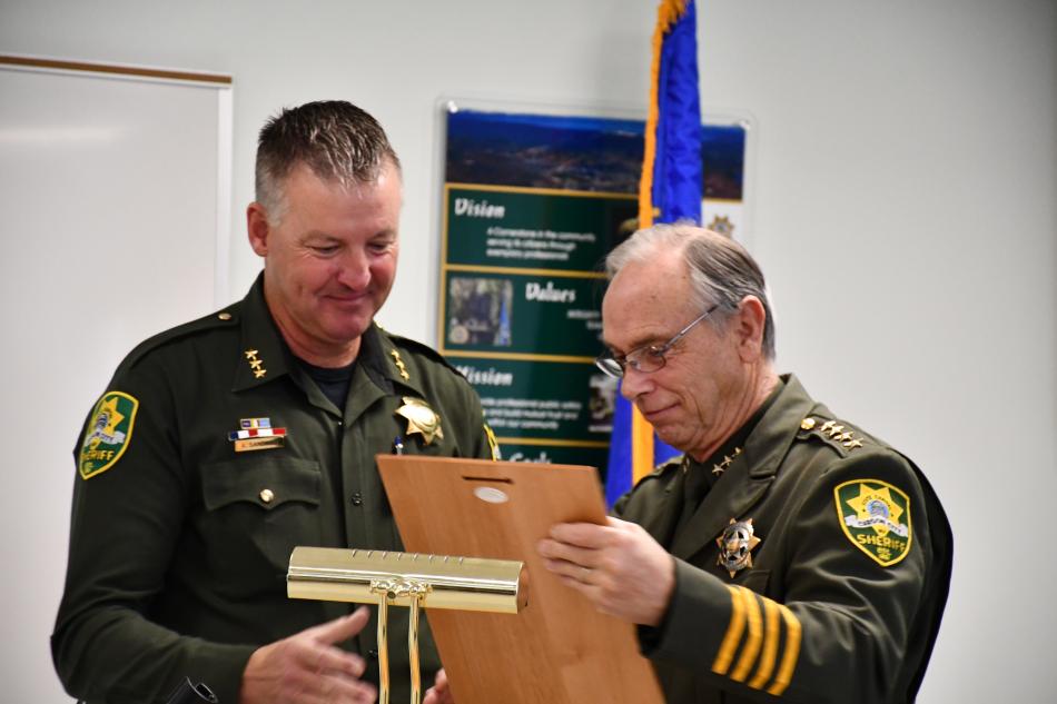Undersheriff Ken Sandage receives a years of service plaque by CCSO Sheriff Ken Furlong. Photos by Rachael Schneider